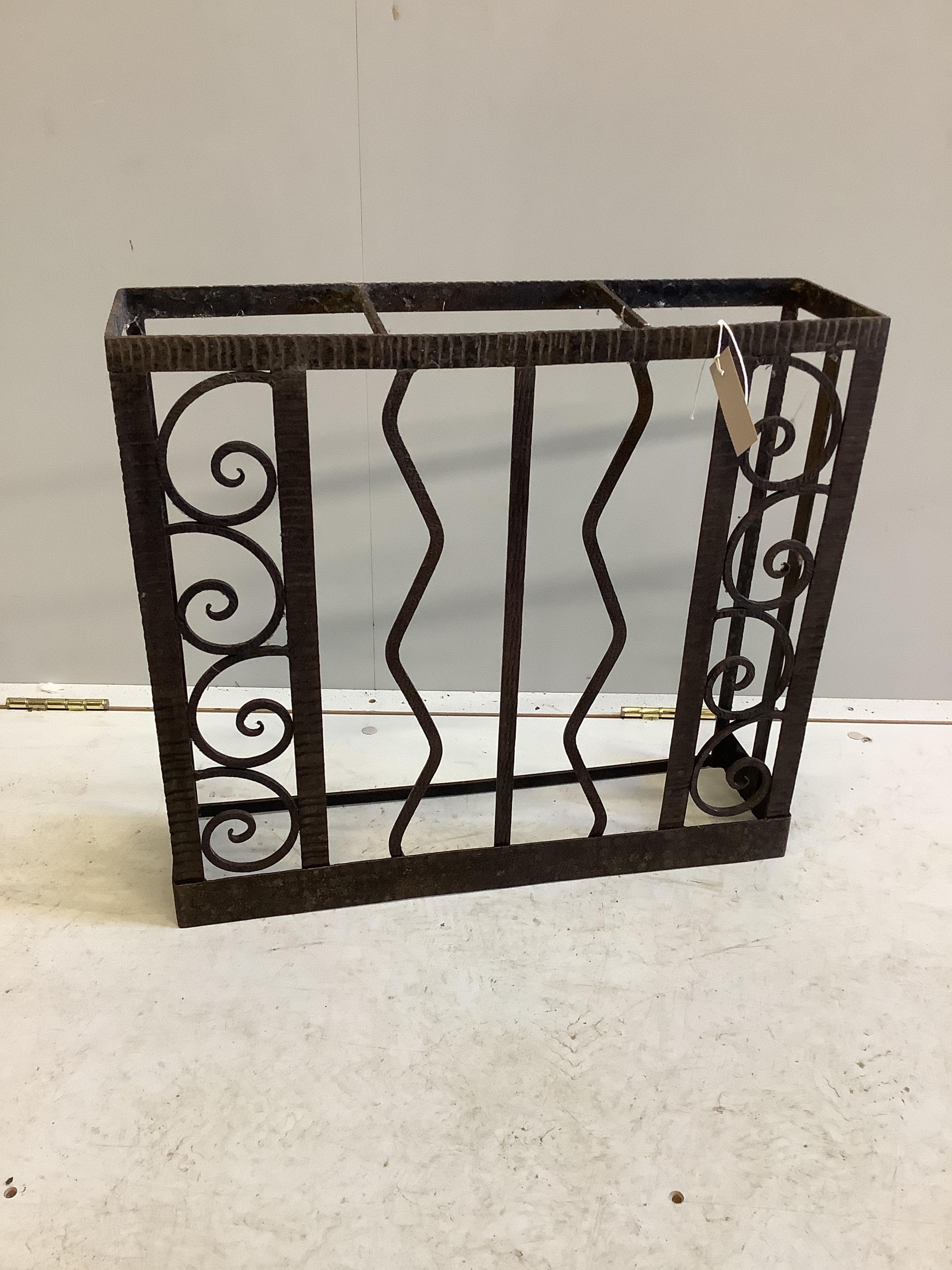 A French wrought iron three division stick stand, width 55cm, depth 15cm, height 50cm